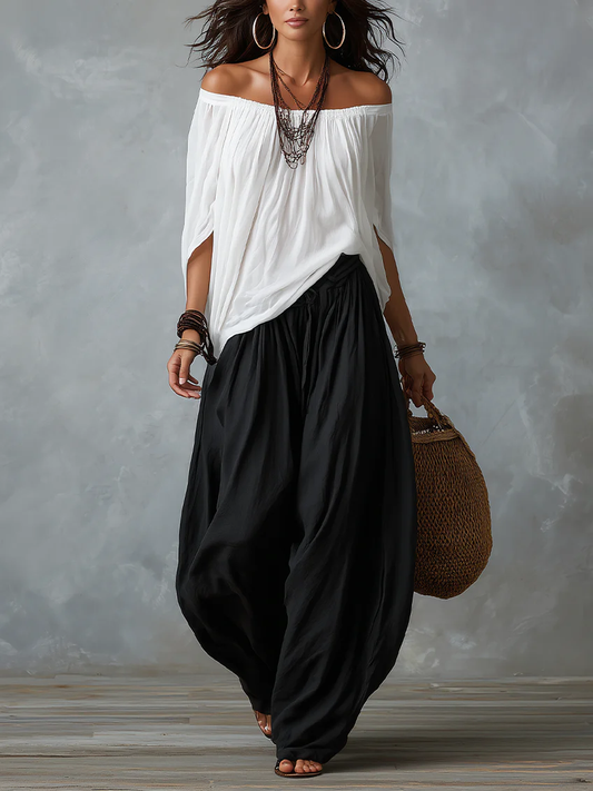 Blusa blanca con hombros descubiertos y pantalón fluido negro