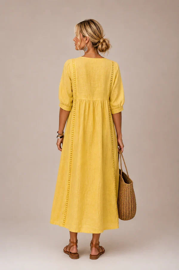 Vestido medio de verano amarillo con mangas abullonadas y bordado en la parte trasera
