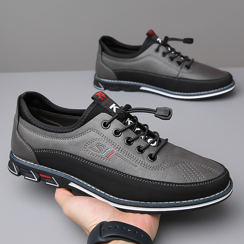 Zapatos Oxford de piel gris con cordones negros y suela negra con bordes blancos