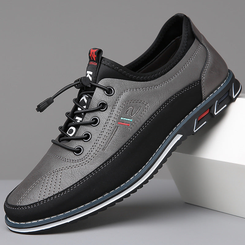 Zapatos Oxford de piel gris con cordones negros y suela negra con ribete blanco