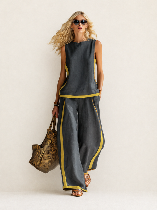 Conjunto de dos piezas gris oscuro: top sin mangas y pantalón ancho con ribete amarillo.