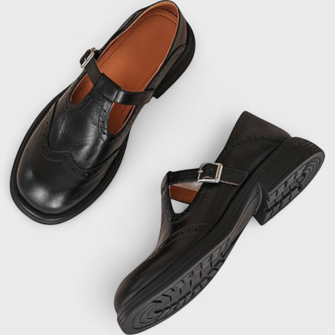 Zapatos estilo mocasín de cuero negro y marrón con hebilla y empeine perforado